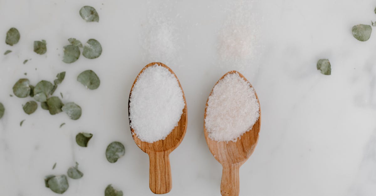 A wooden spoon, rich with natural grain, lying on a light kitchen counter beside fresh herbs and a chef’s apron—evoking the practical beauty and longevity explored in this guide about how long wooden spoons last.