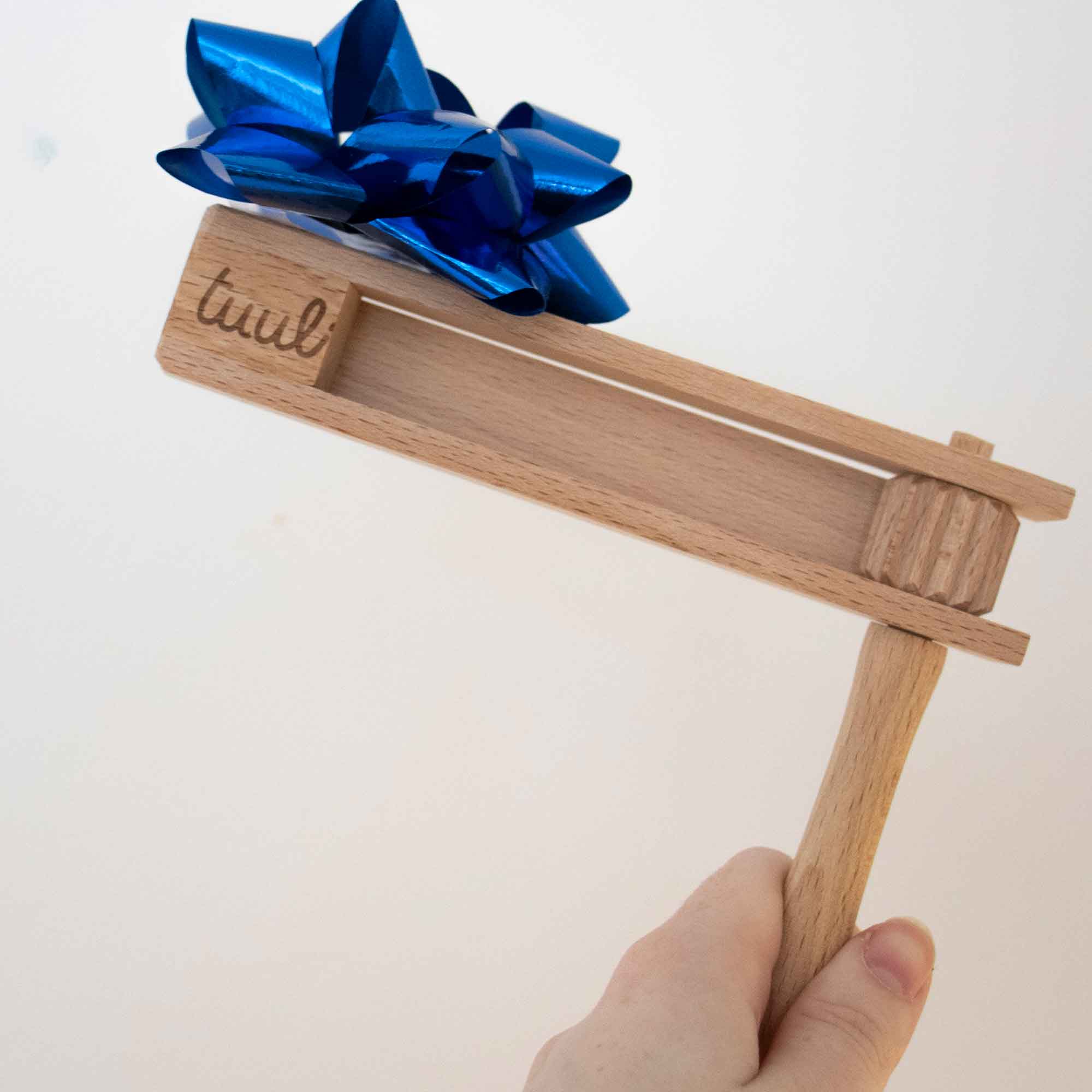 Wooden gift item with a blue bow shown as a wooden gift idea