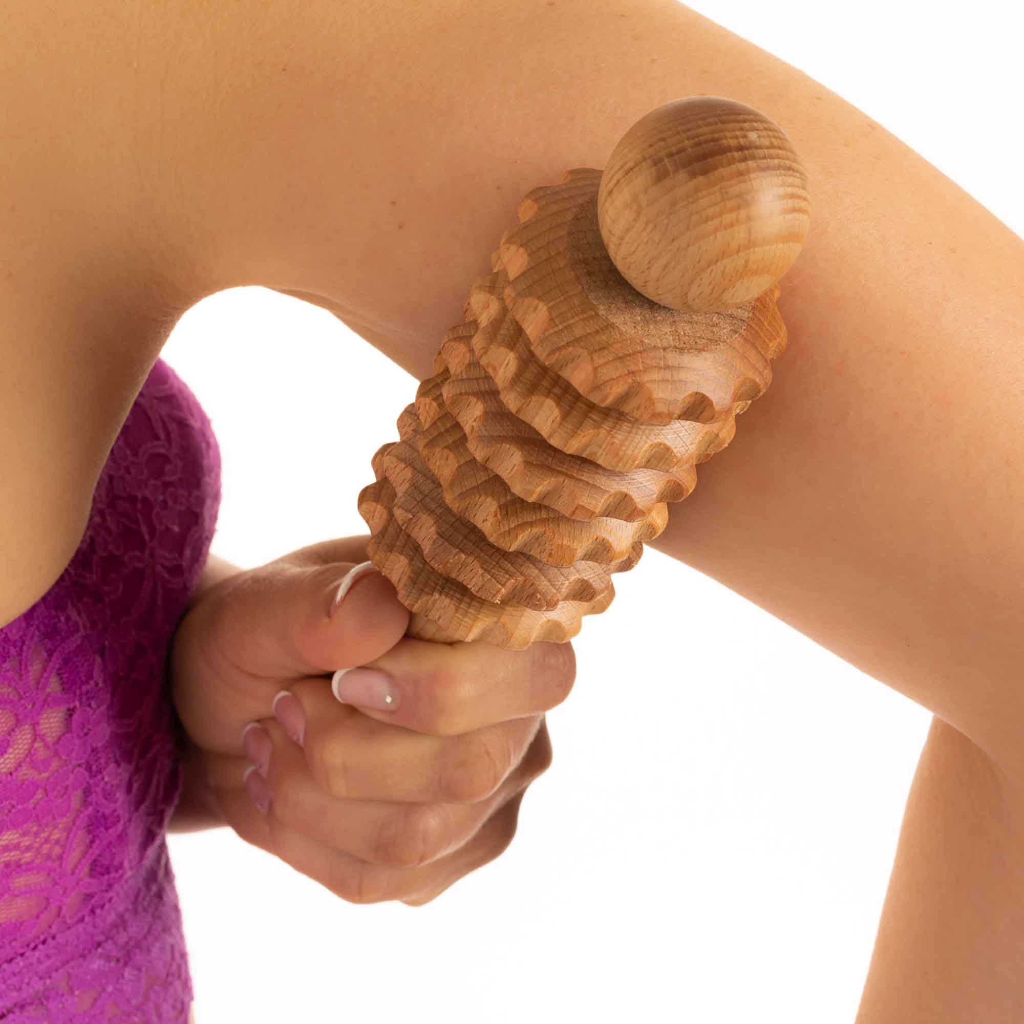 Wooden massage roller used as part of a gentle self-care routine
