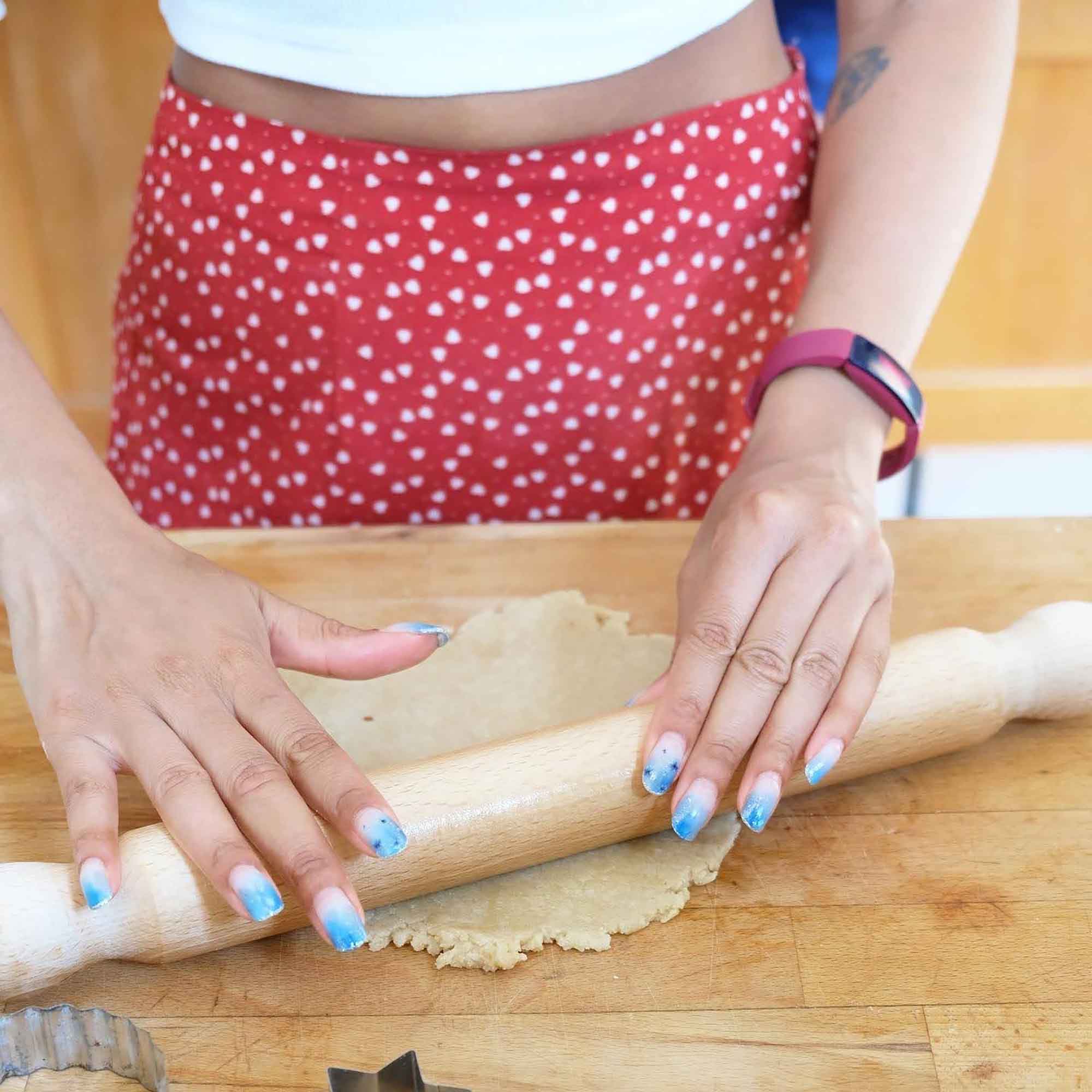 Wooden rolling pin used to roll dough on a kitchen surface