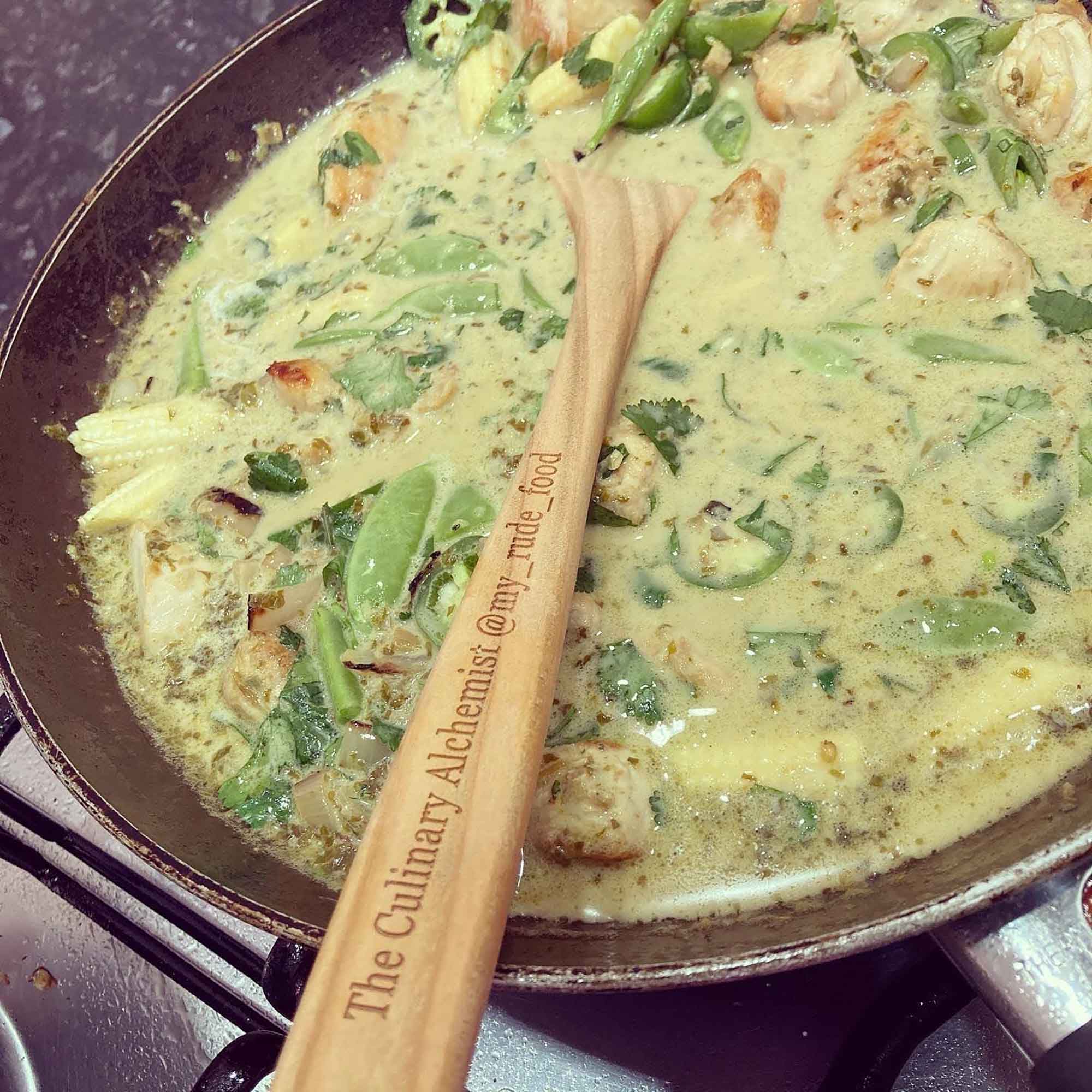 Wooden spoon resting over a hot pan during everyday cooking