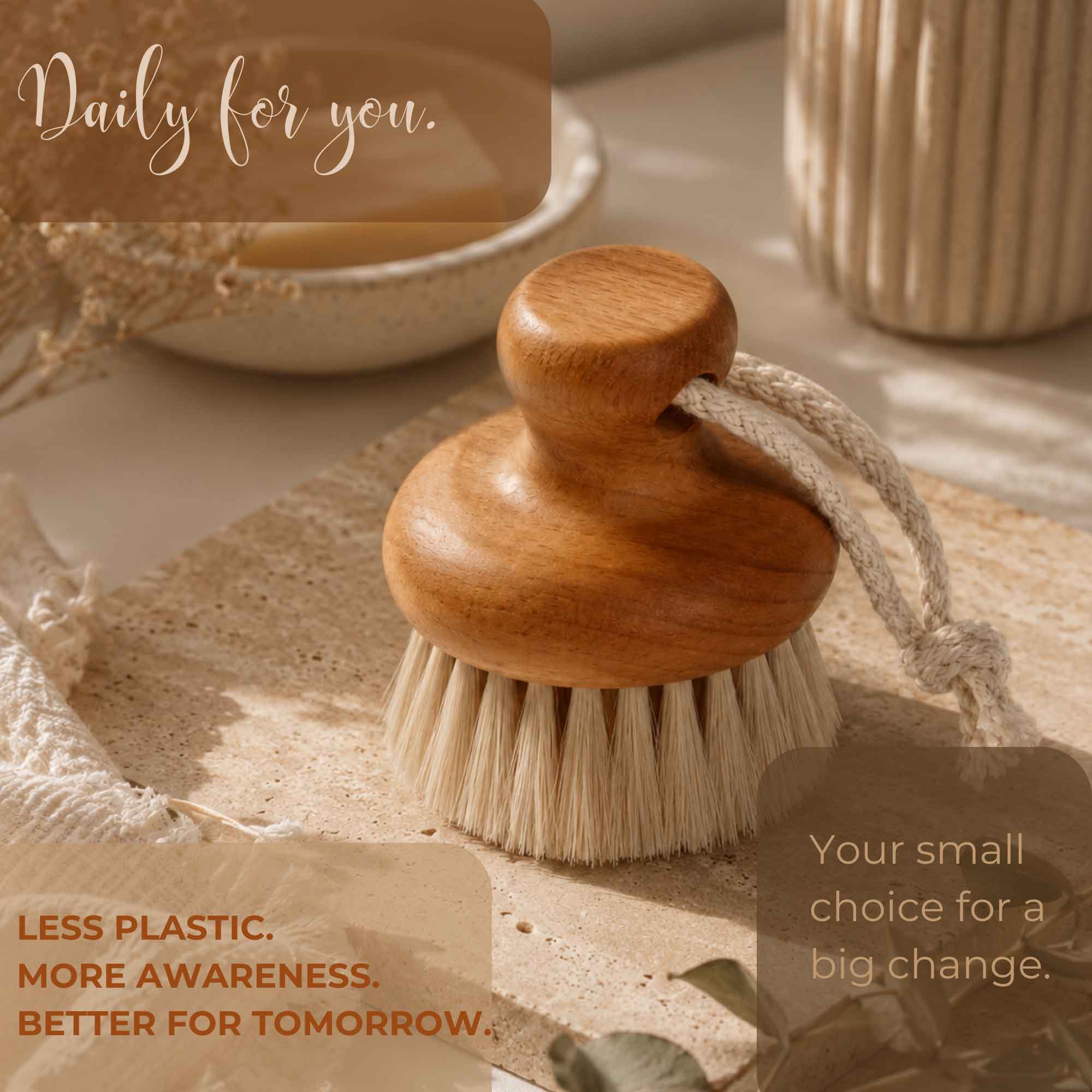 Brosse nettoyante pour le visage en bois de hêtre présentée sur une surface en pierre à côté de décorations de salle de bain