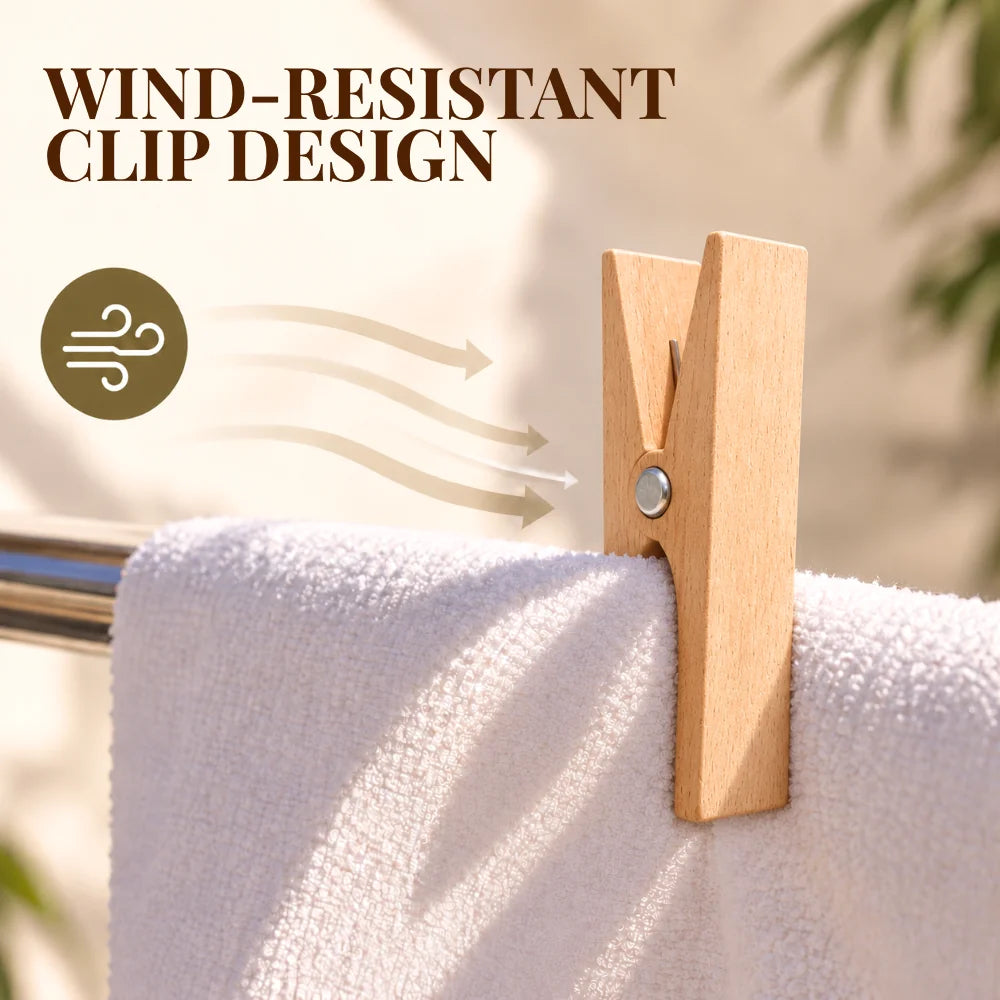 A light natural wood clothes clip holding a white towel on a metal rack, with the text 'WIND-RESISTANT CLIP DESIGN' and a wind icon overlaid on the image.