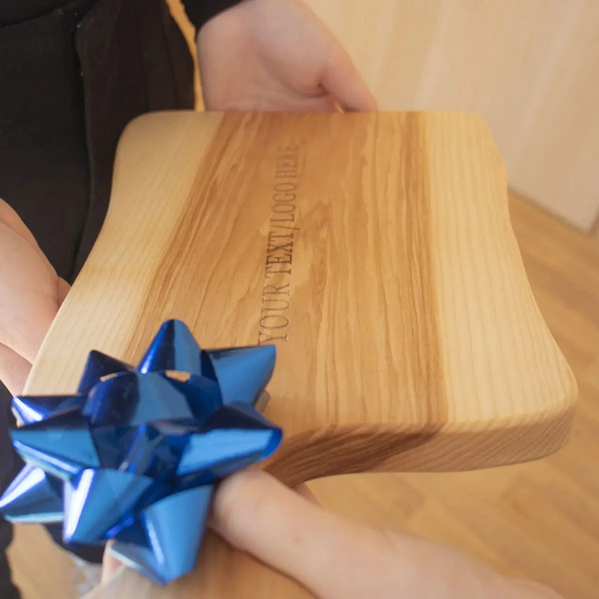 Elegant personalized ash wood cutting board being used to serve charcuterie