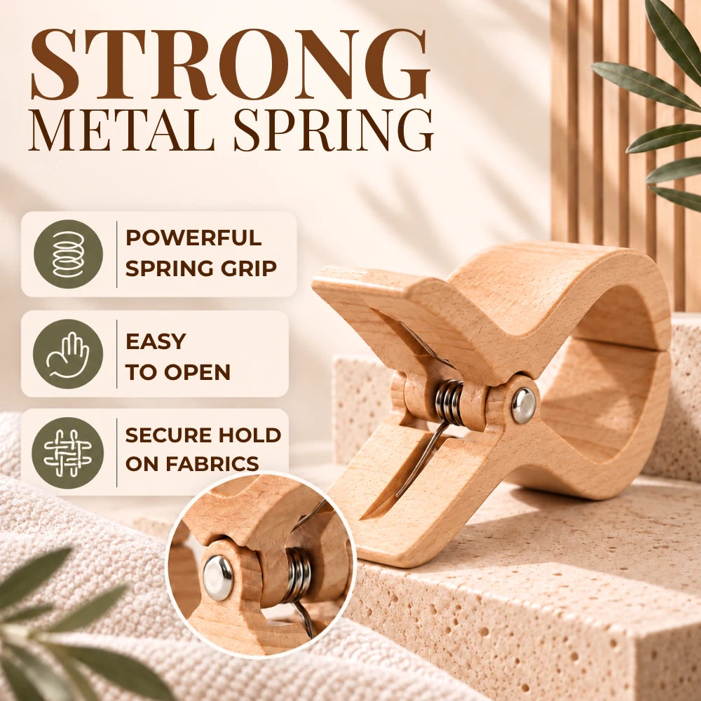 A wooden spring clip with a metal coil spring, shown on a beige stone surface with promotional text reading 'STRONG METAL SPRING' and feature callouts about powerful spring grip, easy to open, and secure hold on fabrics.