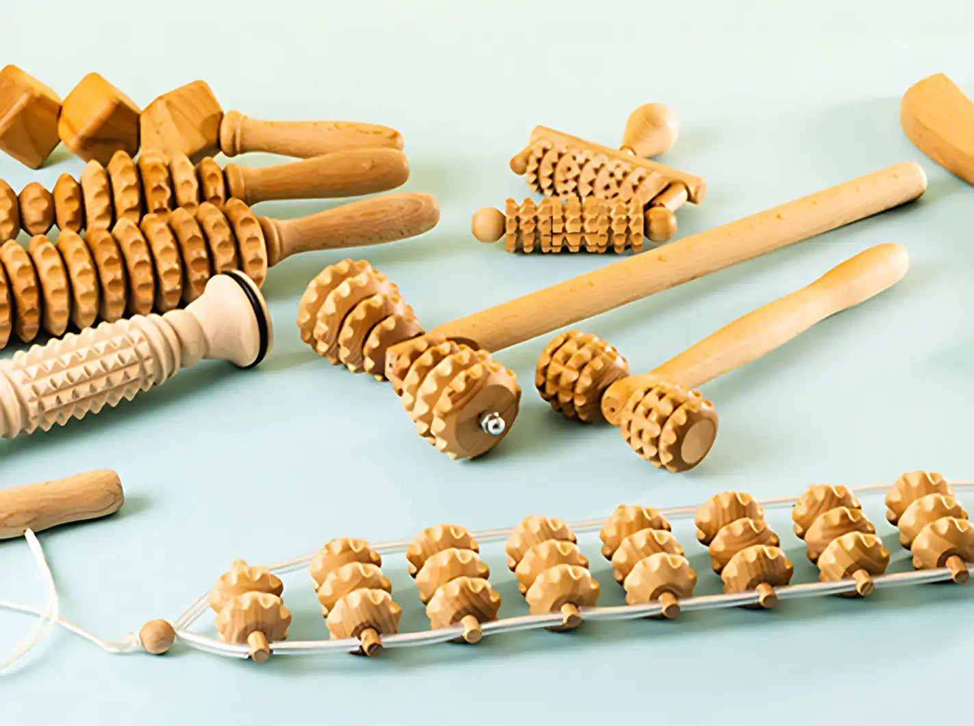 Wooden massage roller set with textured nodes and handles, natural wood color, ergonomic design for muscle relief.