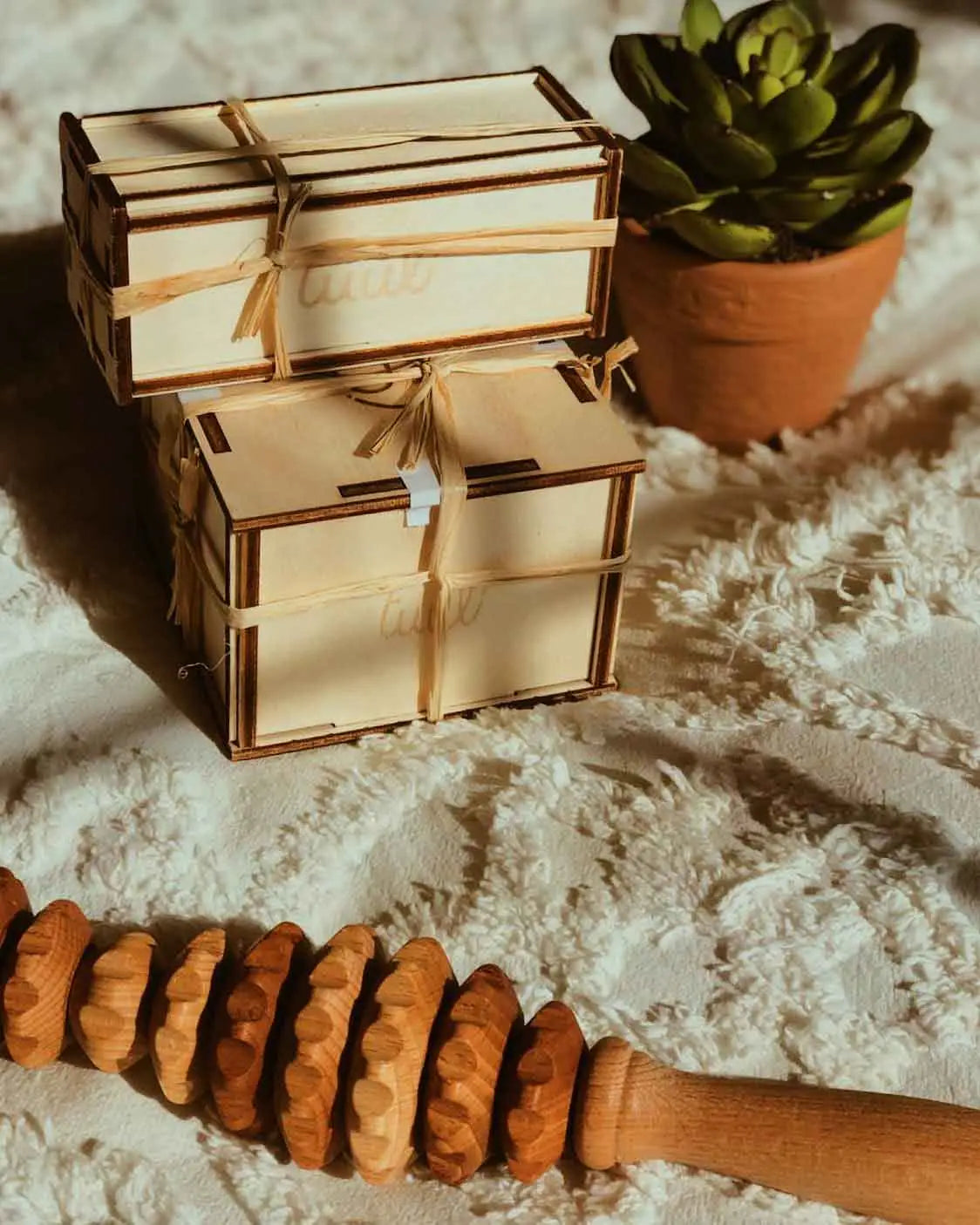 Lifestyle scene: oval roller on bathroom shelf with towel and oil