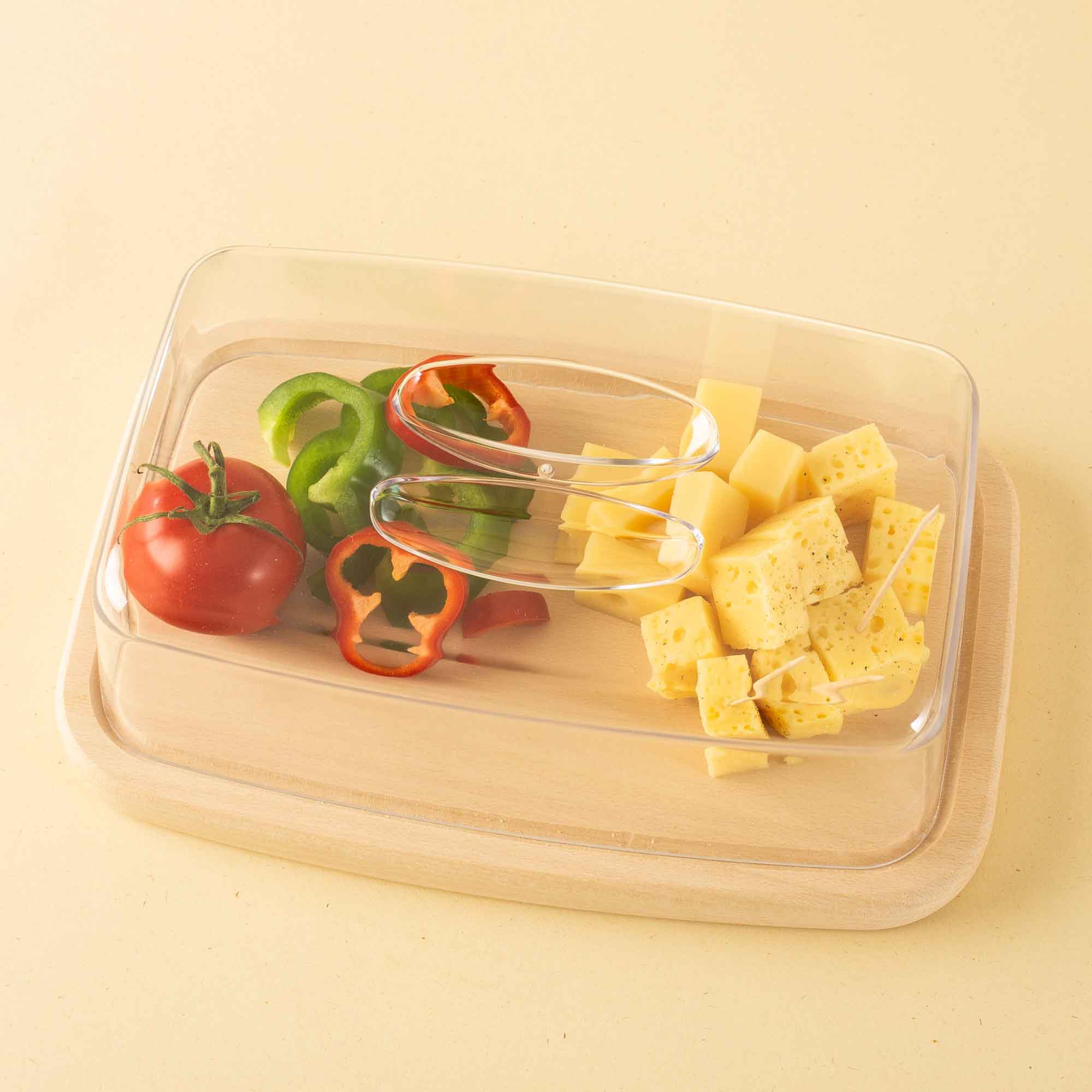 Wooden cheese board with cheese, peppers and tomato for effortless hosting