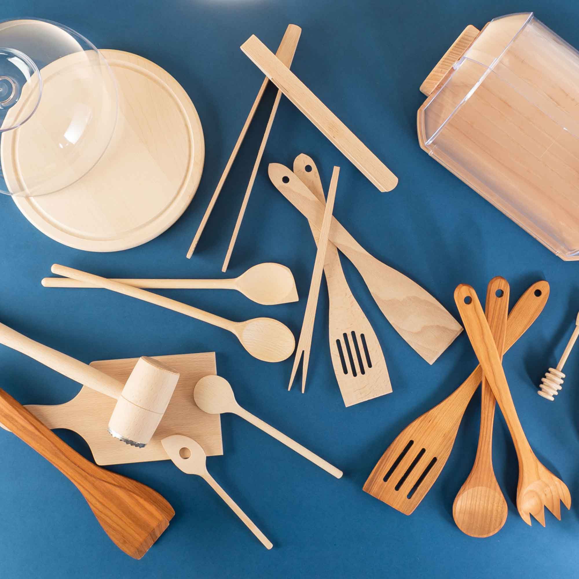 Assorted wooden kitchen and home products arranged on a blue background