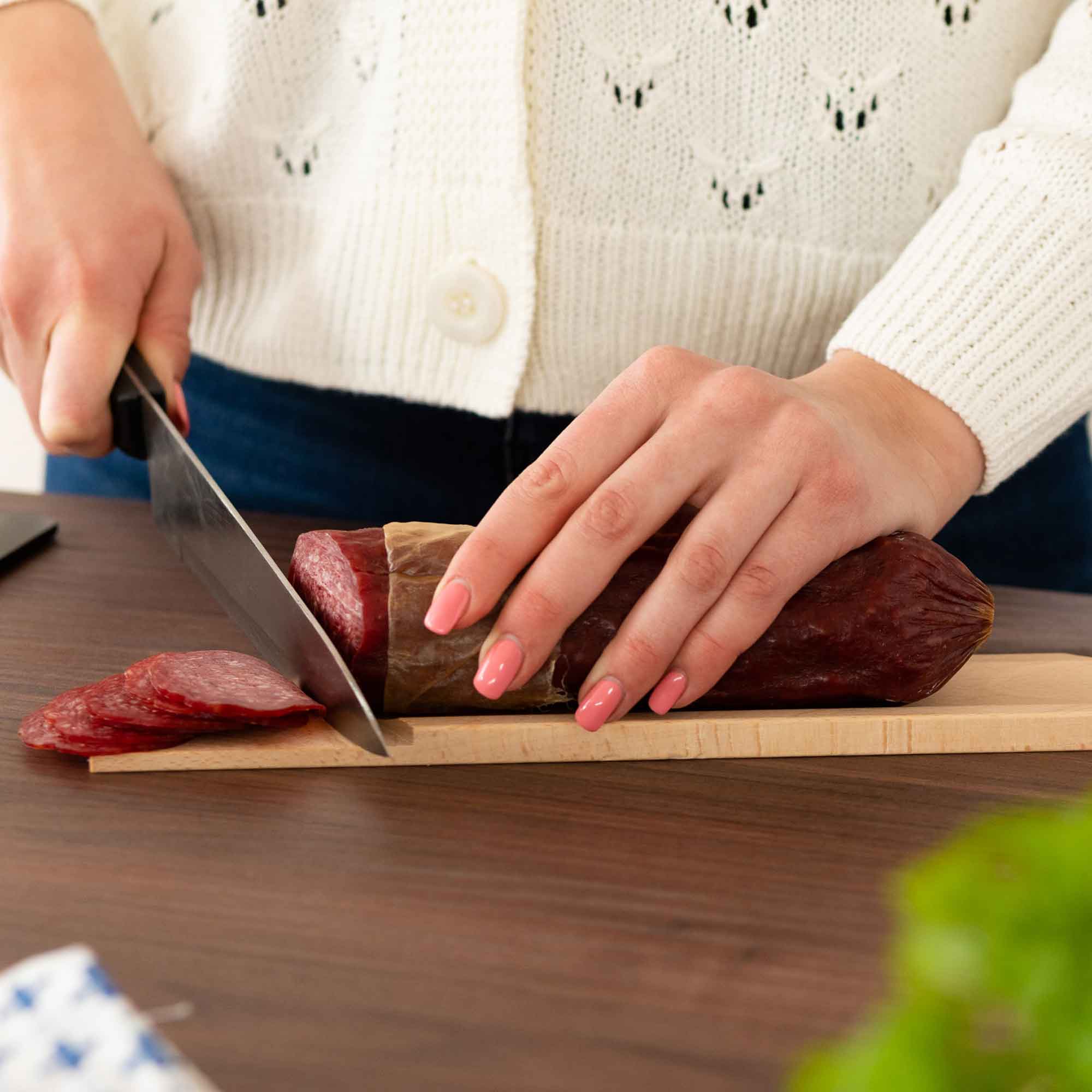 Wooden salami cutting board used to slice salami for serving