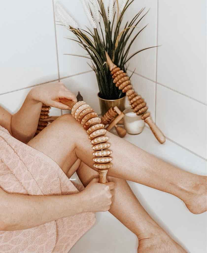 Wooden massage rollers in beechwood—curved, ball, oval and dice profiles—on a neutral background, Tuuli collection