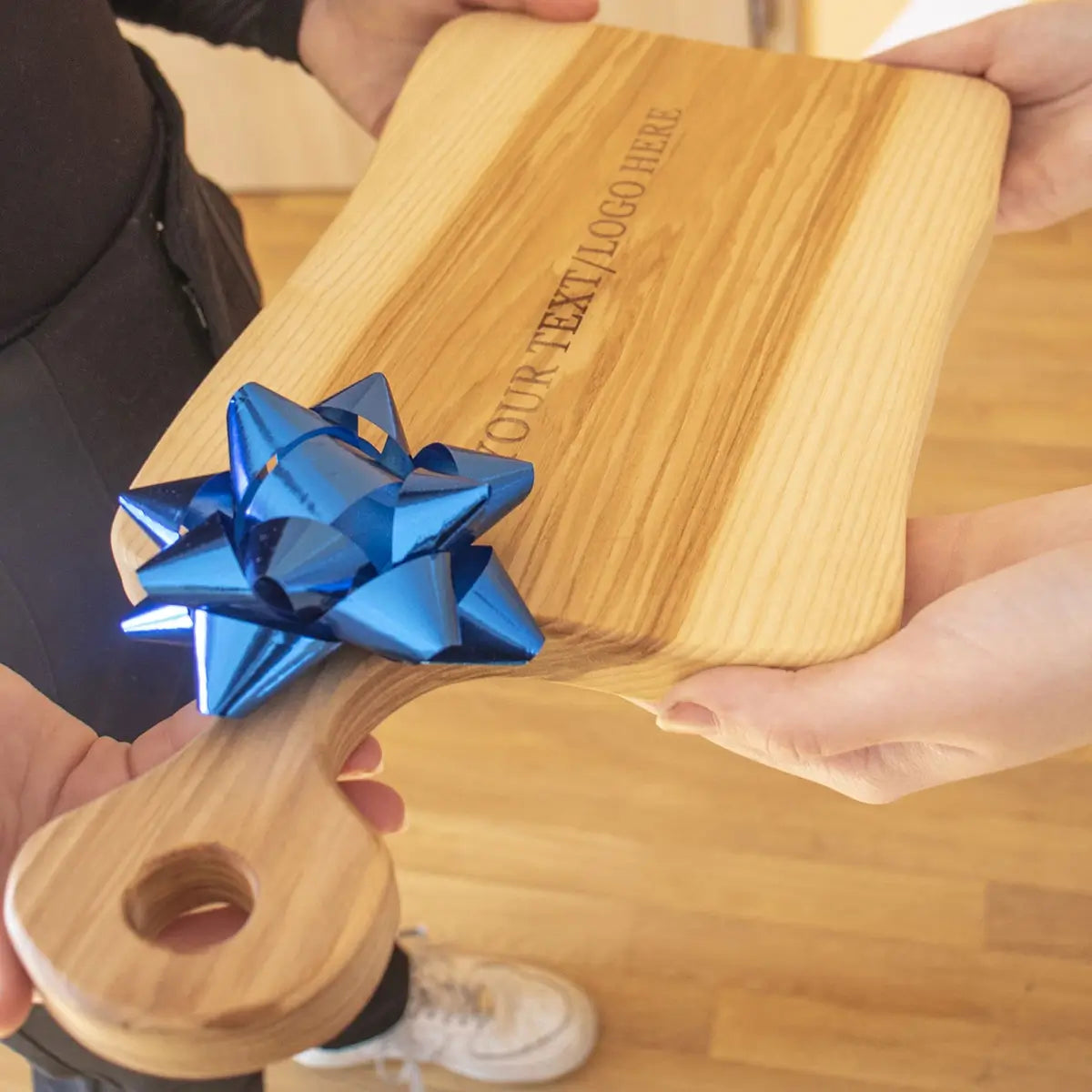 Close-up of precision laser engraving on premium ash wood cutting board