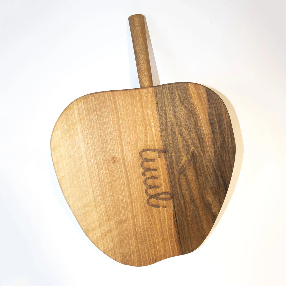 Apple-shaped walnut cutting board serving charcuterie and cheese display for entertaining
