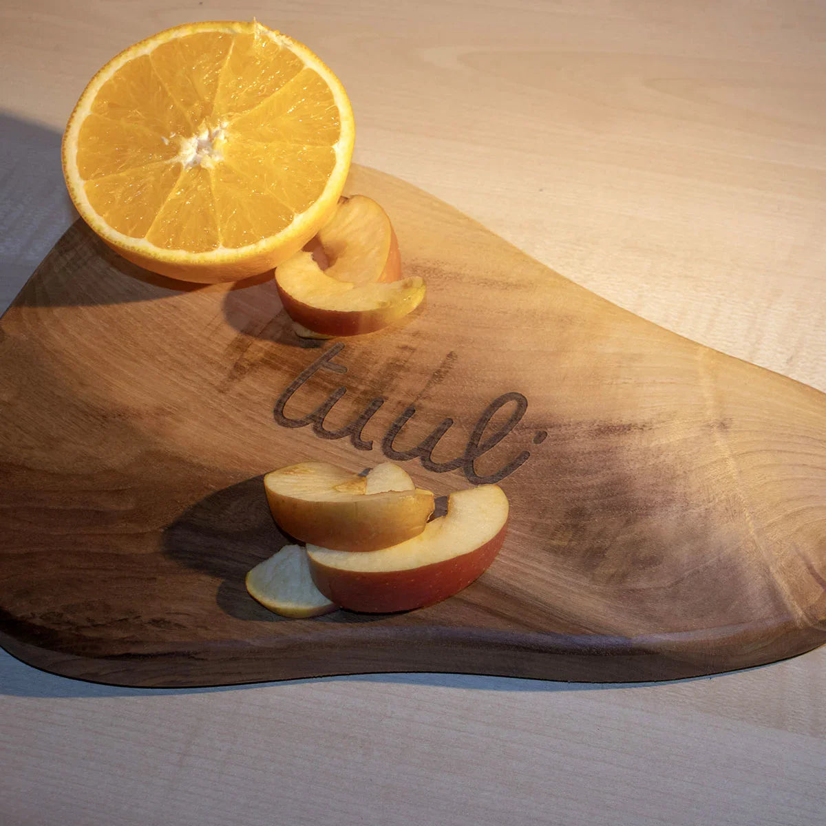 Elegant food presentation using walnut cutting board as serving platter for appetizers