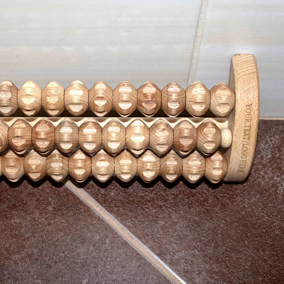 Eco-friendly wooden foot roller being used to relieve tension and foot pain