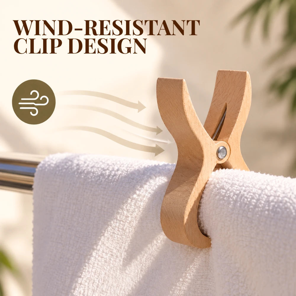 A wooden clothes clip holding a white towel on a metal railing, with the text 'WIND-RESISTANT CLIP DESIGN' and a wind icon overlaid to explain the feature.