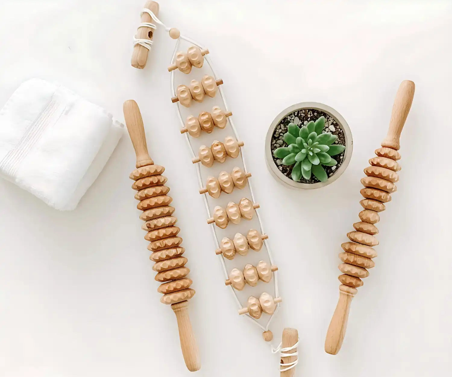 Wooden massage roller with multiple textured nodes, natural wood color and design.